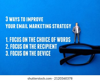 Top View Miniature People And Glasses With Tips For Email Marketing Strategy On A Blue Background. Business Concept.