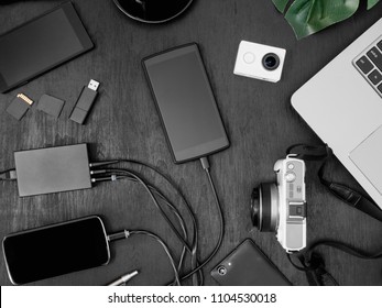 Top View Mobile Phone Charging On USB Wall Charger On Black Table Background.