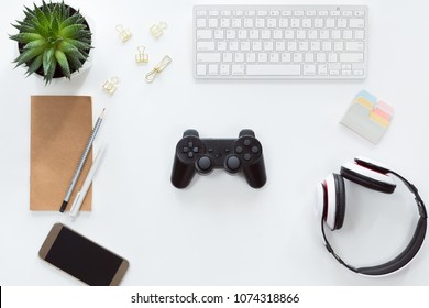 Top View Of Mobile Phone, Computer Keyboard, Notebook On White Background, Flat Lay With Joystick And Gamepad, Game Console, Headphones