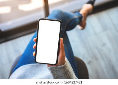 Top view mockup image of a woman holding mobile phone with blank white screen 