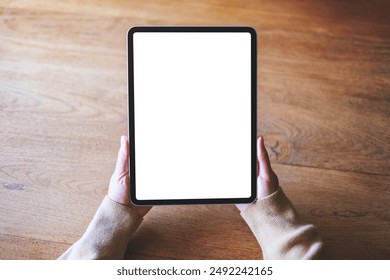 Top view mockup image of a woman holding digital tablet with blank desktop screen