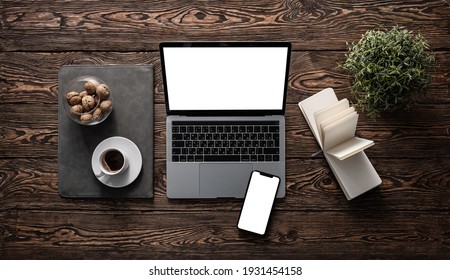 Top View Mockup Of Open Laptop And Smartphone On Old Wooden Desktop.