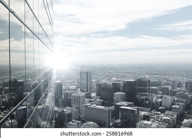 Top View Of Modern City In Lights Of Sunset