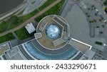 Top view of modern round building with dome. Stock footage. Beautiful architecture of business center with round structure and dome. Rings of building with beautiful facade