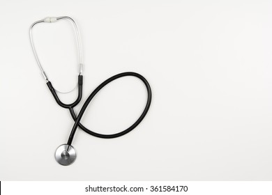 Top View Of Modern, Sterile Doctors Office Desk. Medical Accessories On A White Background With Copy Space Around Products. Photo Taken From Above.