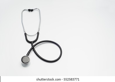 Top View Of Modern, Sterile Doctors Office Desk. Medical Accessories On A White Table Background With Copy Space Around Products. Photo Taken From Above.