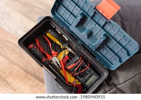 top view of modern toolbox with different instruments
