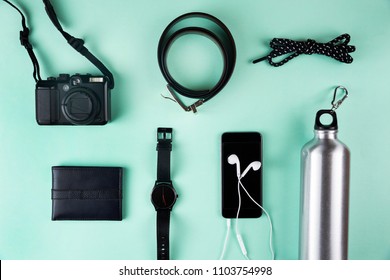 Top view of modren male accessories on blue background. Wallet, watch, mobile phone. Minimalist style.
 - Powered by Shutterstock