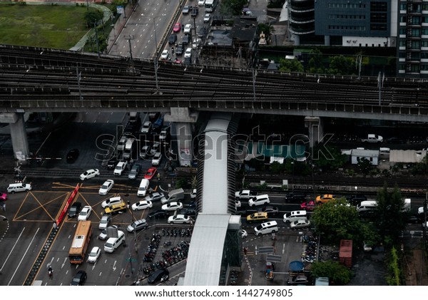 a top view of The most\
traffic corner in Bangkok Thailand while the cross over bride is\
under renovation. Shoot on Friday evening. Asoke road corner in\
July 2019