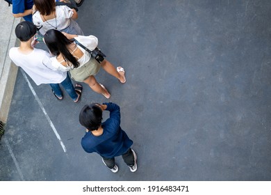 Top View Of Motion Blur People Are Standing In Public Space On Concrete Pavement Landscape. Concept In Aerial View Of Man And Woman Couple Of Teenage With Empty Space.