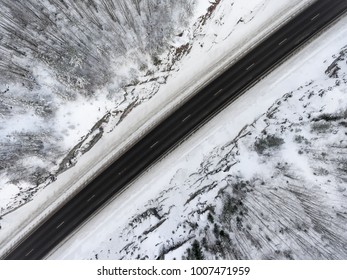 Top View At The Mountain Highway In North Of Russia, Snowy Rocky Terrain And Asphalt Road