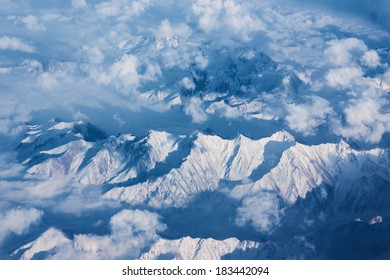 Top View Of Mountains With Snow And Clouds.