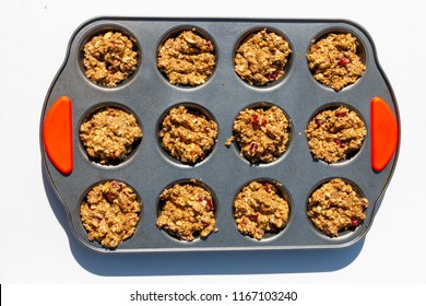 A Top View Of A Muffin Pan With Uncooked Bran Muffin Mixture Waiting To Go In The Oven On A White Background 