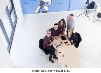 top view of multi ethnic startup business people group on brainstorming meeting in modern bright office interior - Shutterstock ID 382253731