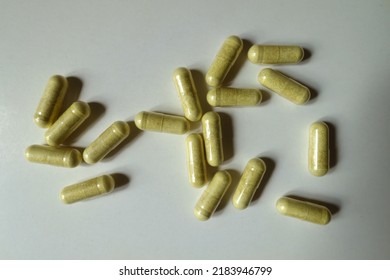 Top view of multiple yellowish green capsules of quercetin dietary supplement