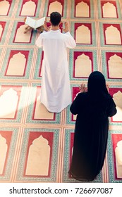 Top View Of Muslim Man And Woman Praying In Mosque