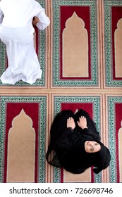 Top View Of Muslim Man And Woman Praying In Mosque