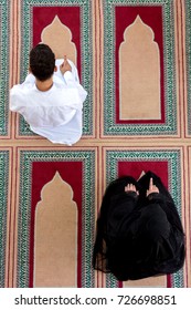 Top View Of Muslim Man And Woman Praying In Mosque