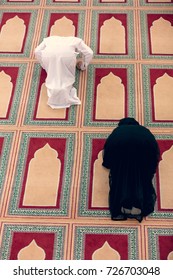 Top View Of Muslim Man And Woman Praying In Mosque