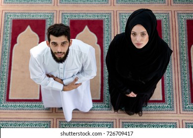 Top View Of Muslim Man And Woman Praying In Mosque