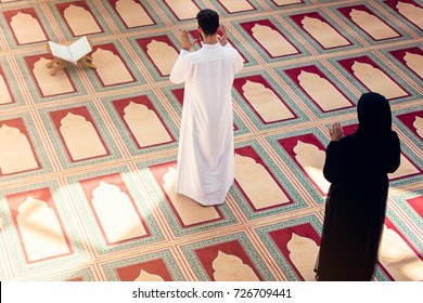 Top View Of Muslim Man And Woman Praying In Mosque