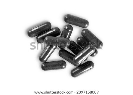 Top view of Natural carbon or charcoal capsules herb drug isolated on white background. Stock photo © 