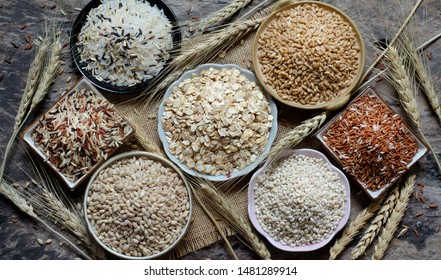 Top view of natural cereal food ingredients consisted of rice,wheat,and pearl barley in the bowl on grunge background in dark tone - Powered by Shutterstock