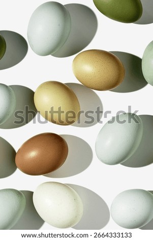 Top view natural easter Eggs with shadows on light background, minimal trend food pattern from assorted organic Chicken egg with neutral earth color eggshells, Easter food celebration concept
