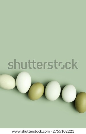Top view natural easter Eggs green color with shadows on green background, minimal trend food pattern from organic Chicken egg with color gradient eggshells, Easter food celebration concept, copyspace
