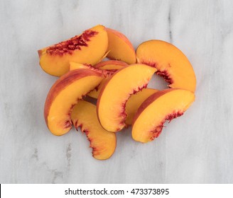 Top View Of Nectarine Slices On A Marble Cutting Board.