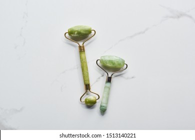 top view of nephrite massage rollers on marble surface