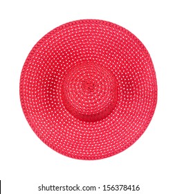 Top view of a new large brimmed red straw ladies hat on a white background.