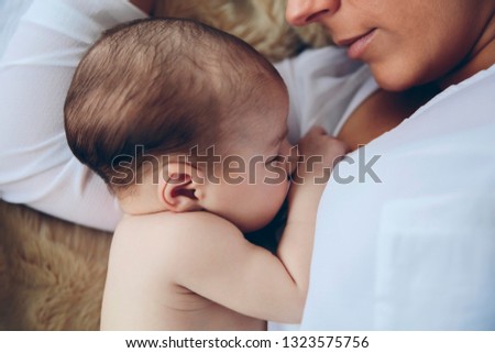 Similar – Mother hugging her newborn baby girl