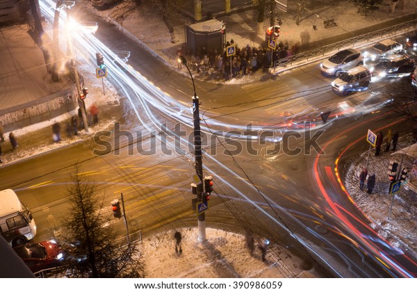 Top view of a night\
crossroad in winter