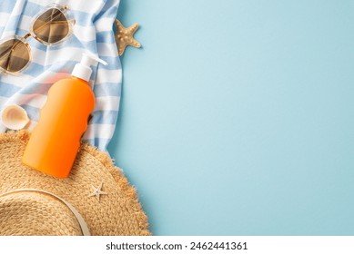 Top view of no-label SPF product, straw hat, sunglasses, beach blanket, seashells, starfish on pastel blue. UV protection and moisturizing concept with space for text or advert - Powered by Shutterstock