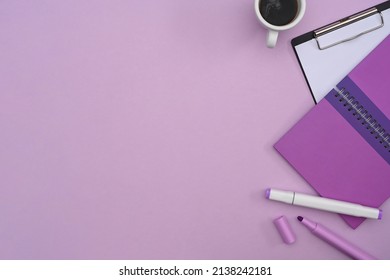 Top view notebook, clipboard and coffee cup on purple background with copy space. - Powered by Shutterstock