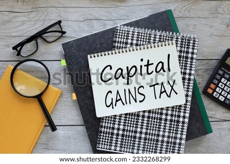 top view of a notebook on a folder. text on the page capital gains tax
