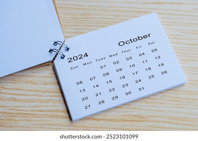 Top view of October 2024 calendar on wooden background. Calendar month of year 2024 concept. - Powered by Shutterstock