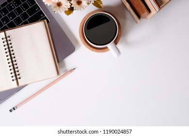 Top view office desk computer keyboard, books, pencil and coffee cup on workspace. - Shutterstock ID 1190024857