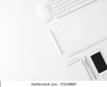 Top View Of Office Desk Work Space With Notebook, Smartphone, Pen, Graphic Tablet On White Background With Copy Space, Graphic Designer, Creative Designer Concept.