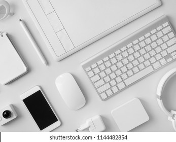 top view of office desk workspace with notebook, graphic tablet, smartphone and gadget on white background with copy space, graphic designer, Creative Designer concept. - Powered by Shutterstock