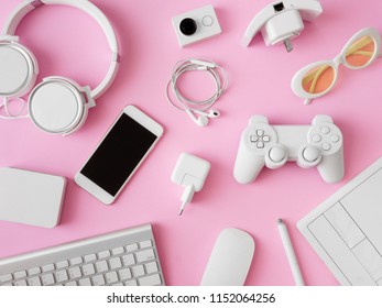 top view of office desk workspace with smartphone, notebook, graphic tablet, keyboard, mouse and gadget on pink color background, graphic designer, Creative Designer concept. - Powered by Shutterstock