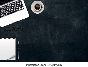 Top View Office Table With Computer, Notepad, Coffee Pen And Plant On Black Background. Flat Lay With Copy Space.