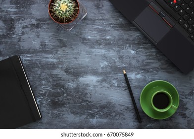 Top view of office work table with laptop, notebook and cup of coffee.