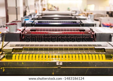 top view of an offset sheetfed printing maschine in a printing facility