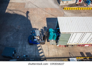 Top View Oil Barrels Forklift Truck Move For On The Transportation Truck