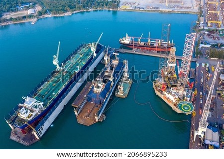 Top view Oil Chemical tanker ships in maintenance area with Drilling Rig over open sea at seaport. Maintenance plant with ships and cars. Oversea transportation, Import-Export Business and Logistic.