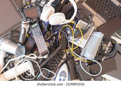Top view to old computers, digital tablets, mobile phones, many used electronic gadgets devices, broken household and appliances. Planned obsolescence, electronic waste for recycling concept