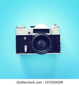 Top View Of Old Photo Camera Over Blue Background