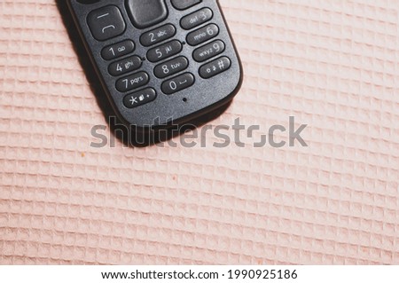 A top view of an old school button mobile on a patterned surface